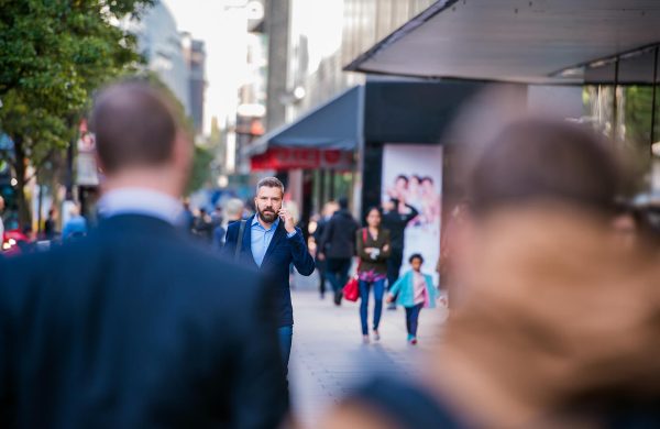 hipster-manager-with-smart-phone-walking-in-the-PFKTPR9(1) Retail & Distribution