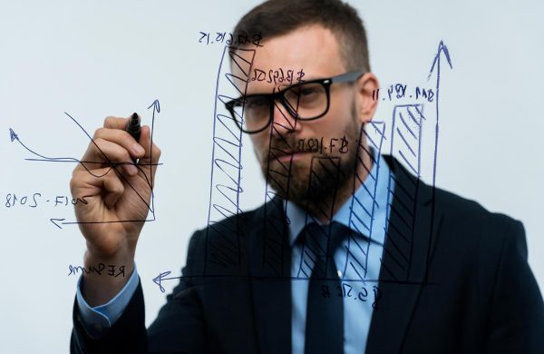 man-draws-various-growth-charts-calculating man-draws-various-growth-charts-calculating